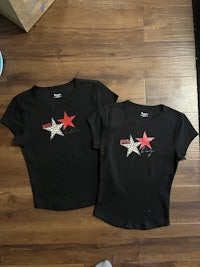 two black t - shirts with stars on them
