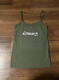 a green tank top with white stars on it