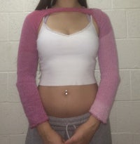 a woman wearing a pink and white sweater