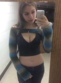 a girl taking a selfie in a mirror