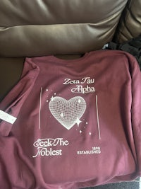 a maroon t - shirt with a heart on it