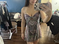 a woman taking a selfie in a dressing room