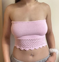 a woman wearing a pink crocheted top